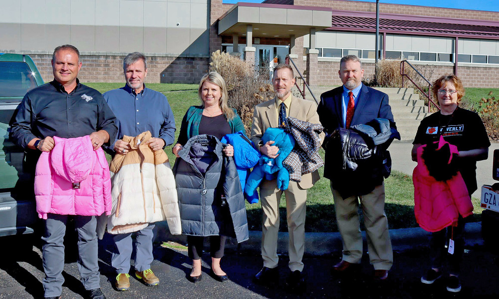 From left, FBP President and CEO Greg Wilkett, FBP Chief Operating Officer James Miller, FBP Admin. Jessica Thorpe, Waverly City Schools Superintendent Ed Dickens, COPE Director Brack Montgomery, and COPE Coordinator Terry Dunham display coats that were collected by FBP employees for donation.